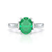 Platinum Emerald oval center with trillion shaped diamonds Engagement ring
