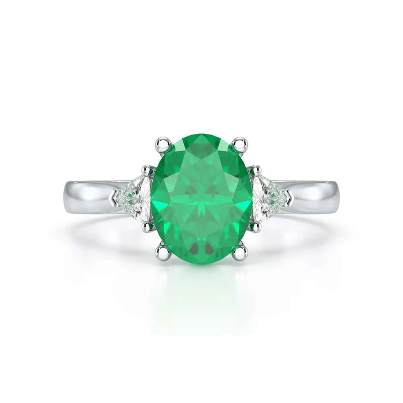 Platinum Emerald oval center with trillion shaped diamonds Engagement ring